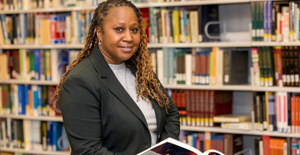 adult student in library looking at camera