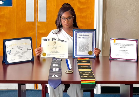 student displaying their certificates and achievements before graduation